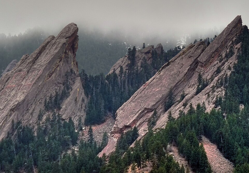 The Flatirons rising above trees near Boulder, Colorado.